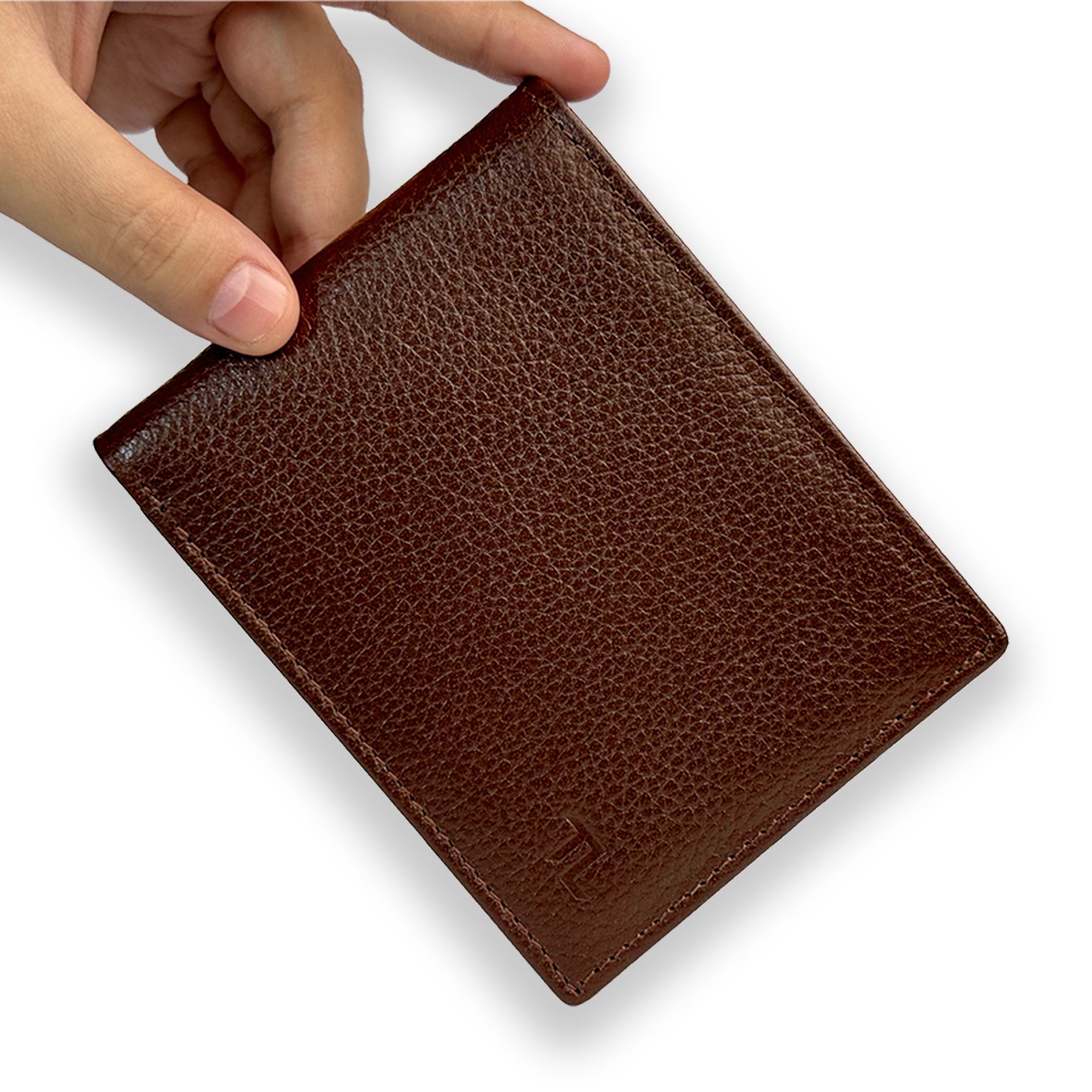 Brown leather wallet held by a hand on a white background